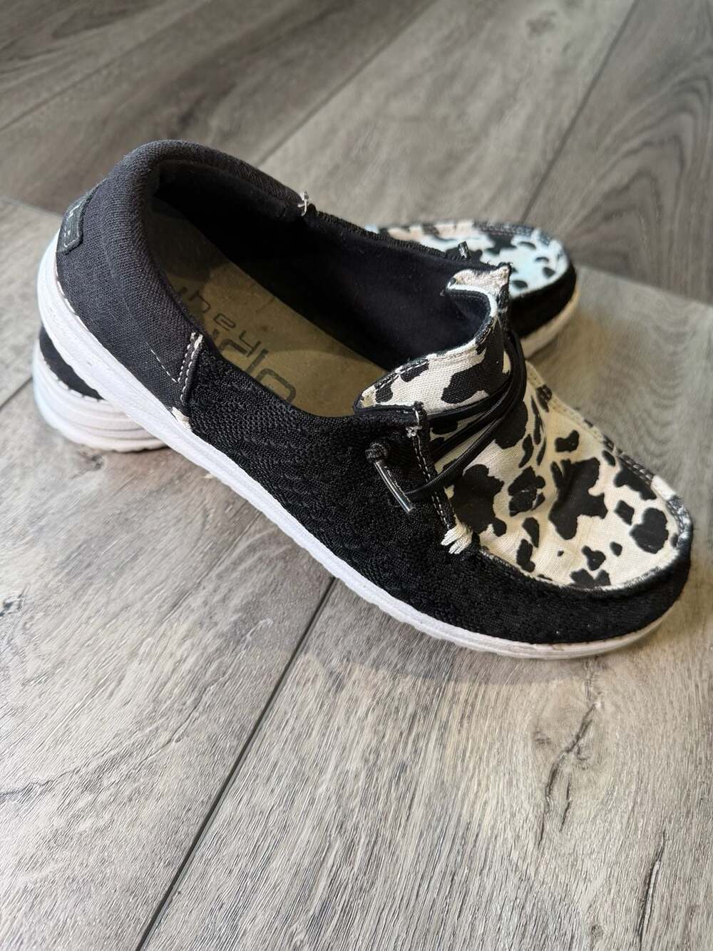 Hey Dude Wendy Cow Print Slip On Shoes Black White